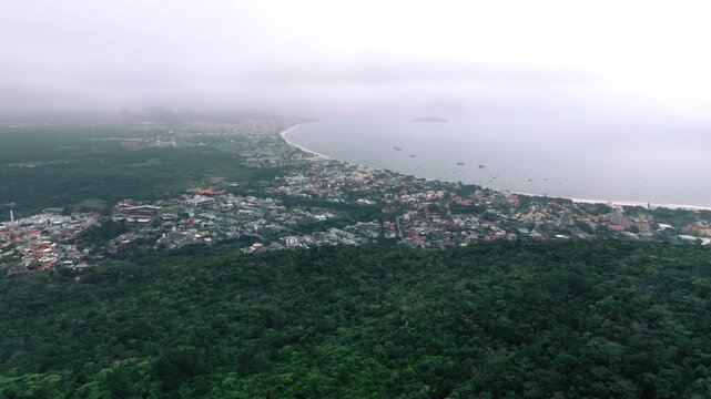 Wide drone panorama of Ingleses bay and town in soft haze