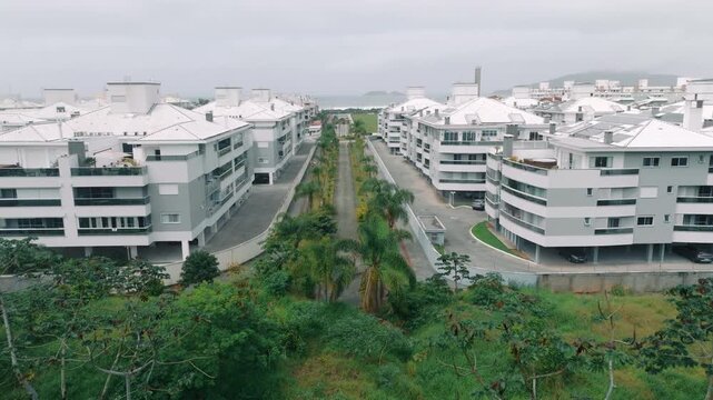 Drone flying between apartment blocks toward Ingleses Beach