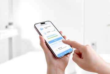 Fototapeta premium User tapping hydration reminder app on smartphone, drinking water tracking and healthy daily habit concept in bright minimal space