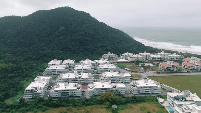 Condominiums beside rainforest hill and beach in Ingleses