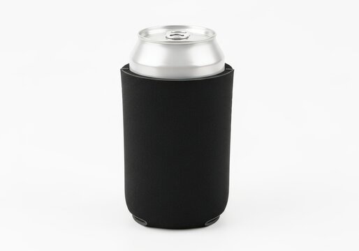 A standard aluminum beverage can inside a simple black neoprene koozie on a plain white surface