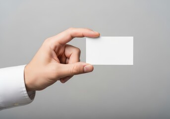 Obraz premium A close up view of a professional hand holding a blank white business card for design placement