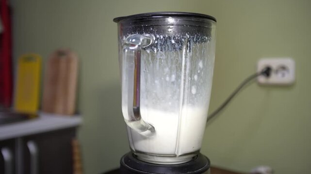 The blender is filled with ingredients to create a smooth milkshake with a creamy texture. The mixing process reveals perfect texture and consistency.