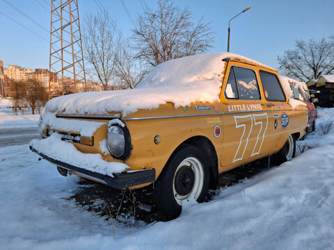 An old Soviet ZAZ 968M sits still on a snow-covered lot