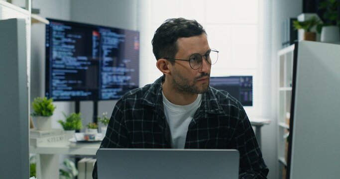 Overworked Caucasian man, a security analyst, developing robust cyber defense. Monitoring network, coding, and managing complex digital systems for business protection.Working.Overworked Security




