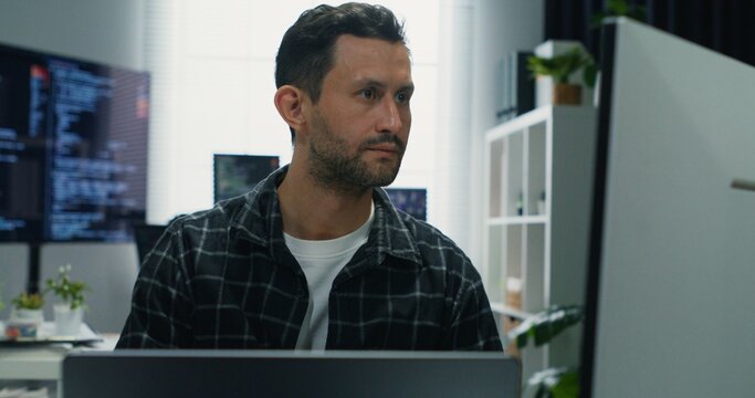 Programmer focused on cyber security. Caucasian man actively monitoring digital systems, managing data, and coding solutions for online network protection.Programmer Securing Network.