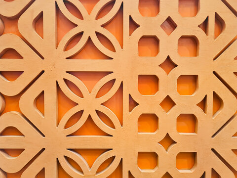Modern terracotta roster decorative panel with traditional repeat geometric and floral patterns. Made from orange terracotta clay with abstract floral patterns and geometric shapes, an artistic feel.