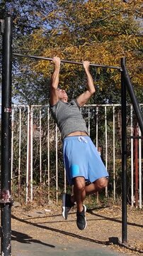 Athletic 54-Year-Old Fit Man Doing Chin-ups - Street Workout. Video is ideal for promoting fitness and outdoor workouts. Series Track Code: Fit-Mature-Man-54-Outdoor-Fitness-Series-2024