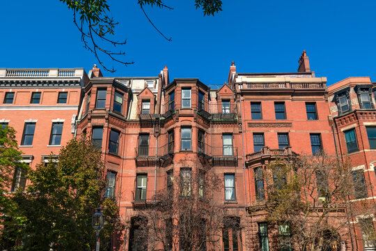 Intricate brownstone architecture and bay windows define the historic facades of homes in Back Bay, Boston.