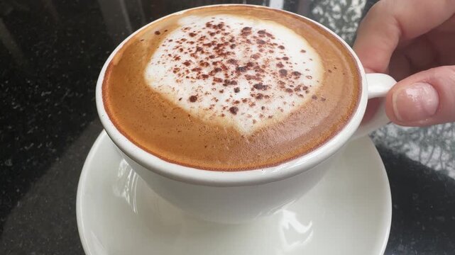 Drinking a Cappuccino Coffee Drink in a Cup