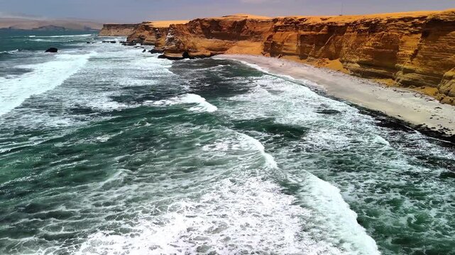 Aerial drone view of the Pacific Ocean and cliffs in Paracas. Dramatic Pacific landscape. Panoramic coastal view. Peru. Region Ica.	
