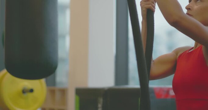 Active Woman Training on Strength Machine in Modern Fitness Center