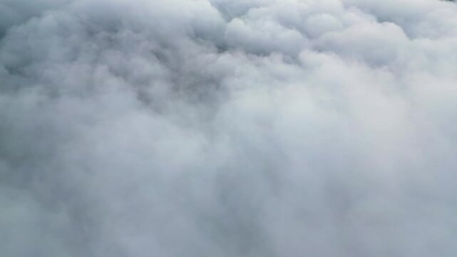 The sky is filled with clouds, creating a moody atmosphere. The clouds are white and fluffy, giving the impression of a peaceful, serene day