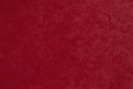 Deep red velvet paper texture background. Dark burgundy blank rough sheet surface for luxury Christmas or elegant premium design