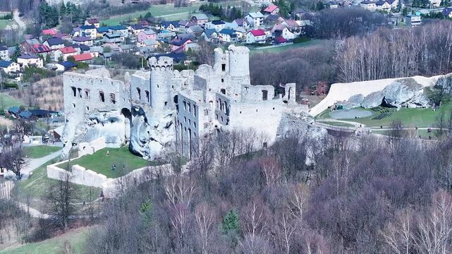 Aerial Poland Zamek Ogrodzieniec castle mountain slide. Ruins of medieval castle south Poland. Original stronghold from 11th century, stone castle built in13th century. Rocky mountain top.