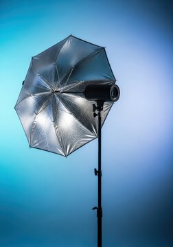 Studio photography silver umbrella reflector equipment setup on a light stand, highlighting texture and professional lighting accessory, portable, reflector, illumination