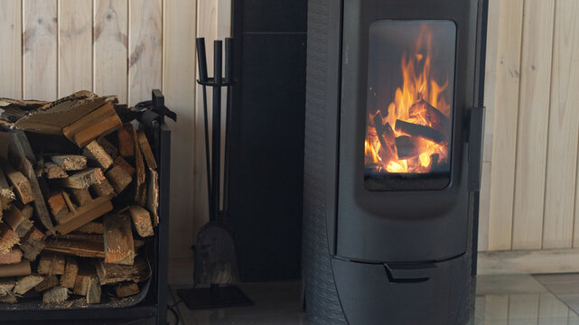 Burning wood in a potbelly stove.