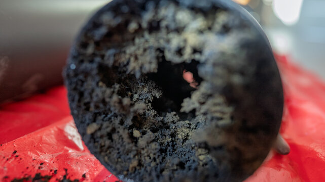 Part of the chimney pipe is almost completely filled with soot.