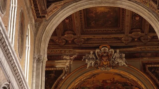 The historic interior of the Naples Cathedral. A Baroque marble sculpture of the Virgin Mary on the altar of the Assumption of the Blessed Virgin Mary, March 6, 2026.