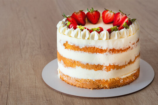 Top view of strawberry sponge cake with cream cheese frosting.copy space