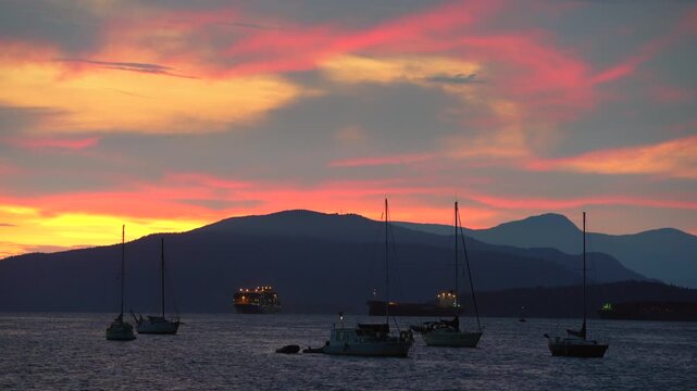 Kitsilano Warm Sunset Summer English Bay 4K UHD. Sailboats at anchor during an English Bay sunset, Vancouver, Canada. 4K. UHD.
