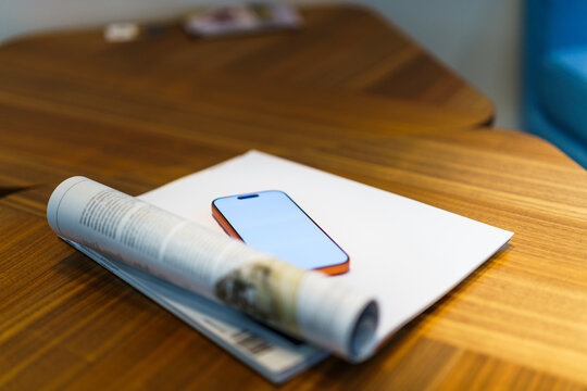 Smartphone mockup magazine wooden table soft focus