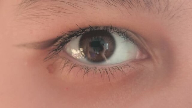 Close-up of a beautiful brown eye with an arrow. Eye makeup. vision problems, myopia, myopia, hyperopia. Ophthalmic diseases