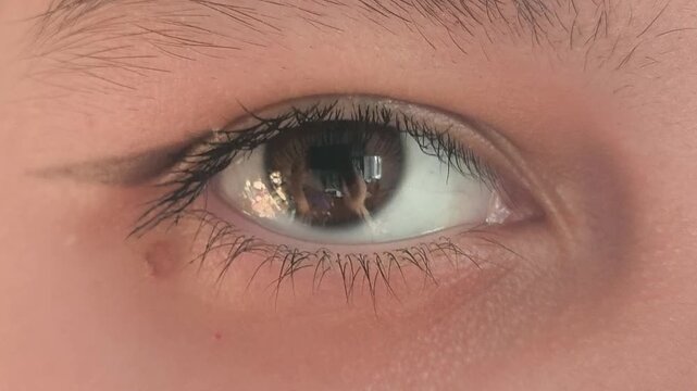 Close-up of a beautiful brown eye with an arrow. Eye makeup. vision problems, myopia, myopia, hyperopia. Ophthalmic diseases