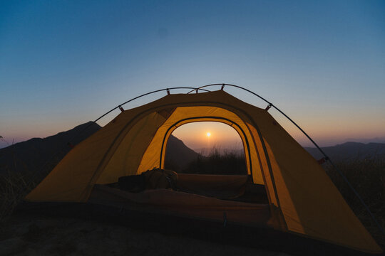 Camping tent high in the mountains. Hiking tour or wild camping and travel concept