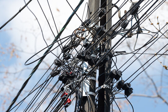 Chaos of telecommunication lines and power cables. Concept of outdated infrastructure.