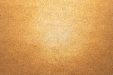 Fototapeta premium Warm golden brown textured canvas background. Vintage grunge painted studio backdrop with light center for elegant antique portrait design