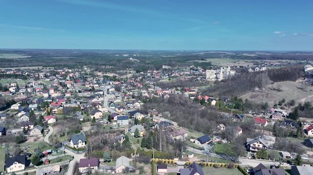 Aerial Poland neighborhood Ogrodzieniec castle pull 2. Ruins of medieval castle south Poland. Original stronghold from 11th century, stone castle built in13th century. Rocky mountain top.