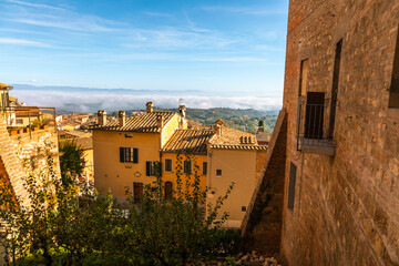 Obraz premium Montepulciano rooftops over foggy Val d'Orcia valley, Italy.