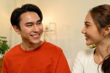 Fototapeta premium Close-Up of Happy Young Asian Couple Smiling and Looking at Each Other