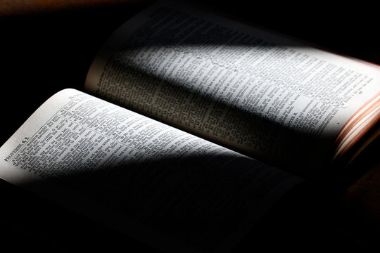 Catholic Bible pages showing Proverbs chapter. Religious book. 