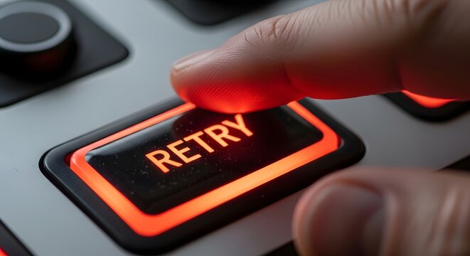 A finger pressing a glowing red retry button on a control panel