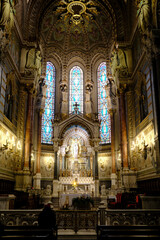 Fototapeta premium Magnificent high altar of Notre-Dame de Fourviere Basilica with stained glass windows and golden statues. Lyon. France.