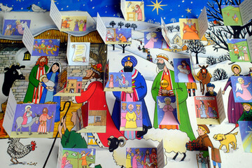 Fototapeta premium Complete opened pop-up nativity storybook with Three Kings, shepherds, angels, and stable scene displayed.