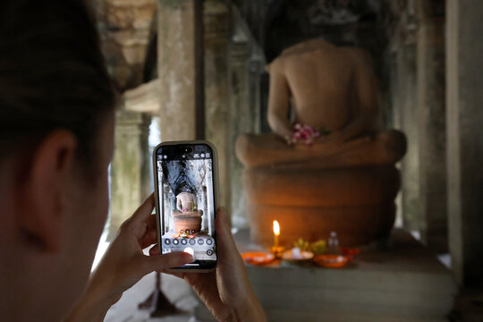 Large headless Buddha statue at Ta Prohm temple.  Siem Reap. Cambodia.