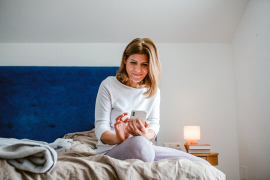 Mature woman reading concerning text on phone.
