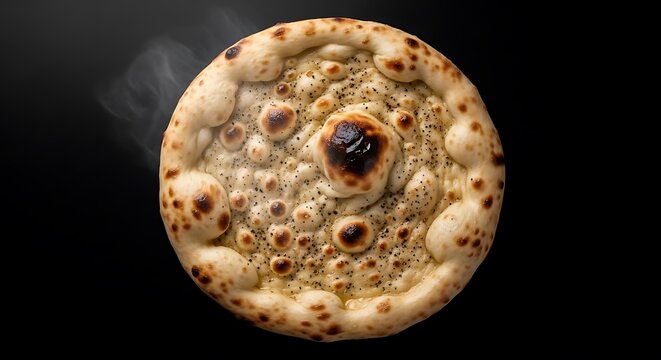 A close-up of a freshly baked, round flatbread with visible bubbles and steam