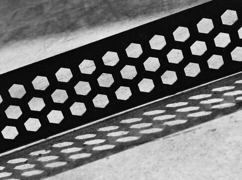 Diagonal perforated black steel surface background