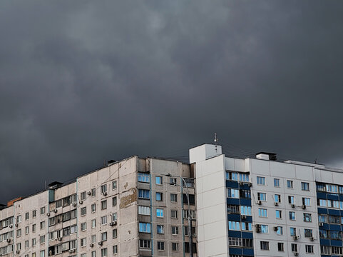 Overcast clouds above old and restored buildings before the rain