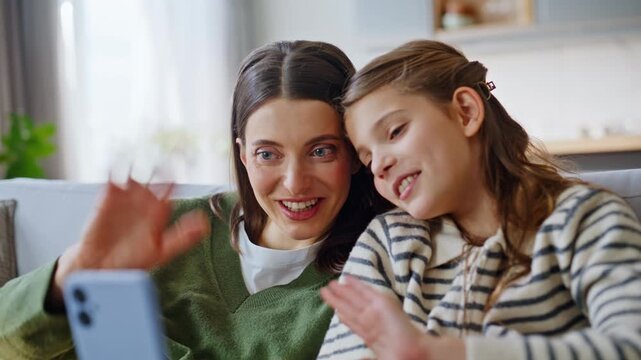 Closeup hands holding smartphone. Mom kid waving cellphone web camera video call