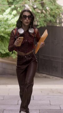 Happy young woman dancing on street steps