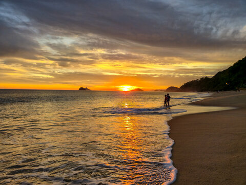 Incredible orange sunset on a paradisiacal beach.