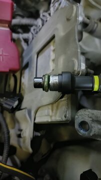 Close-up of a fuel injector with green rubber O-ring