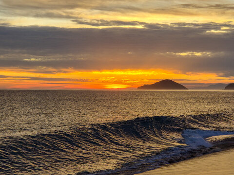 Incredible orange sunset on a paradisiacal beach.