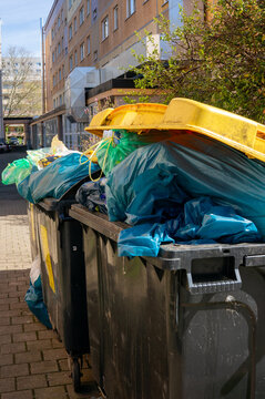 garbage can full with yellow garbage bags plastic waste recycling vertical