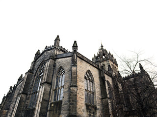Gothic St Giles cathedral exterior in Edinburgh, Scotland, UK with soaring stone spires and stained glass windows against a moody winter sky © AS Photo Family